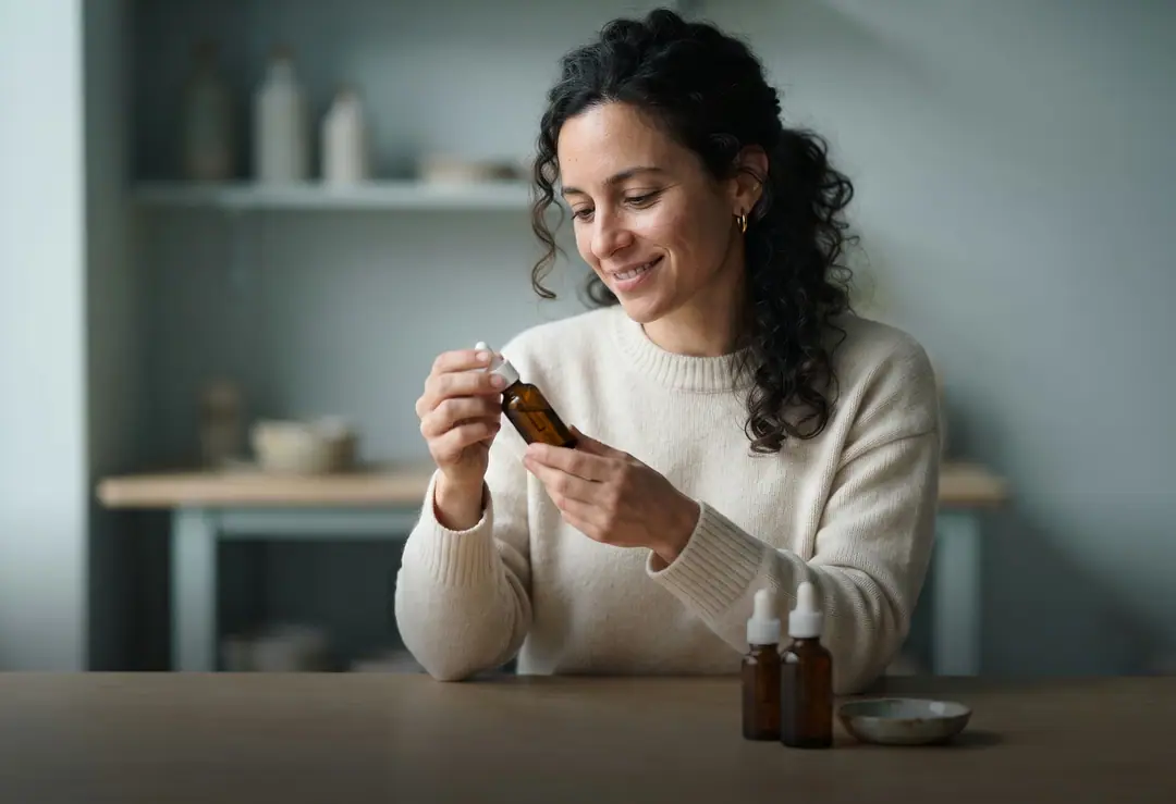 A skincare founder holding her new product
