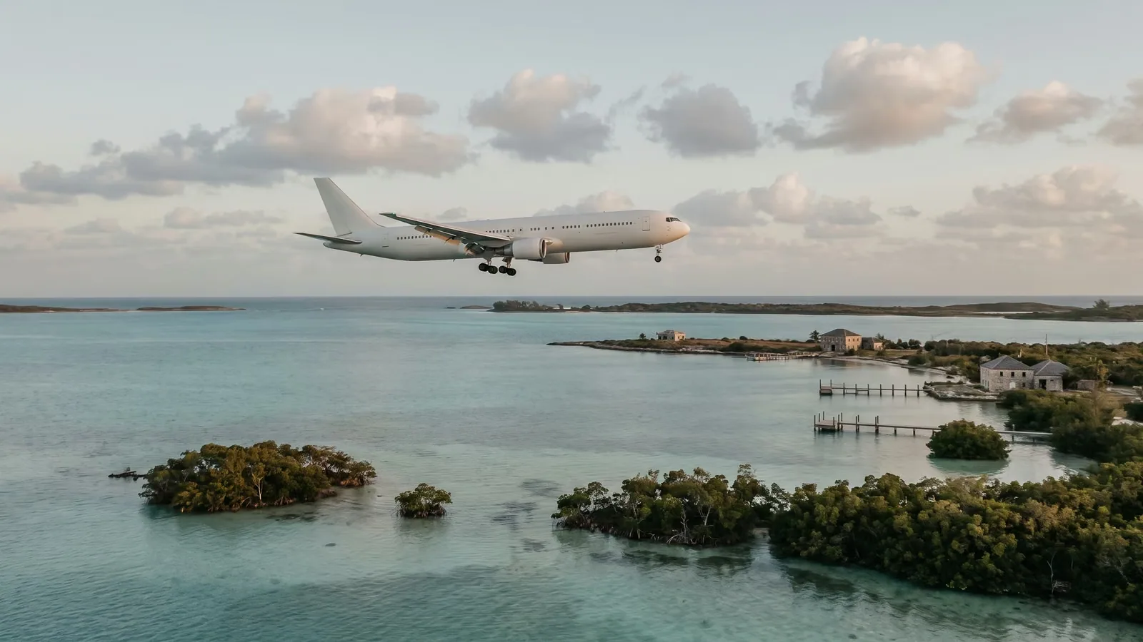 A passenger jet descending over the shallow waters and mangroves near Key West.