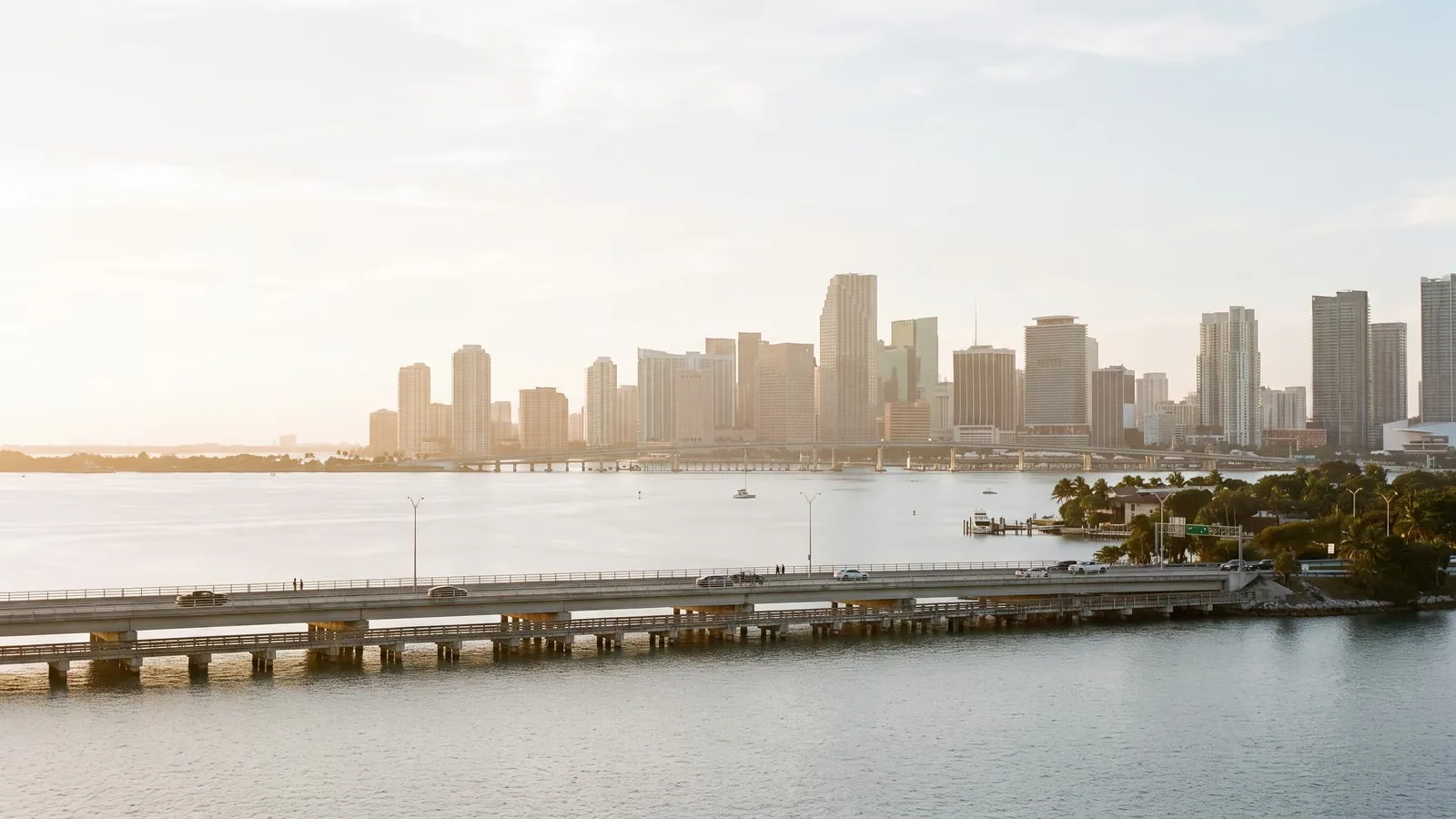 Golden hour aerial view over Biscayne Bay toward the Miami skyline.